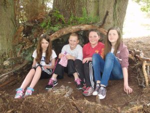 Pleased with their shelter! The Group Leader commented that they were the best shelters he had seen being built and was not going to dismantle them, which he would normally. Well done girls!